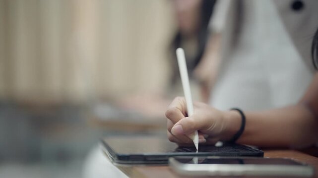 Modern student using a stylus and tablet to organize classroom notes with a smartphone nearby. Great for education, technology, digital literacy, academic planning, and smart classroom concepts.
