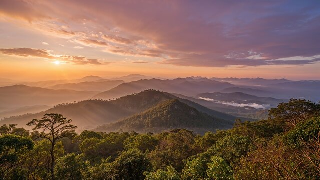 Sunrise over mountainous forest landscape with layers of hills, mist, and a colorful sky.