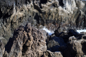 Obraz premium Black lava formations, basalt rocks closeup at the foot of a volcano.