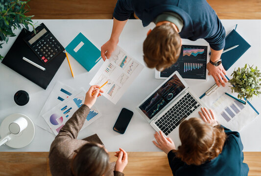 Team Collaboration in Modern Office Analyzing Financial Charts a Business Data