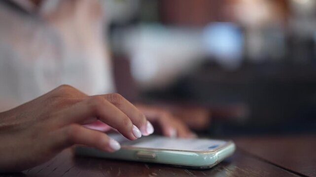 Close-up of female hands interacting with a smartphone for messaging, social media, online services, and digital communication. Perfect for mobile technology, connectivity, and modern lifestyle concep