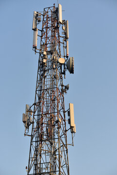 Base station transceiver tower against clear blue sky background