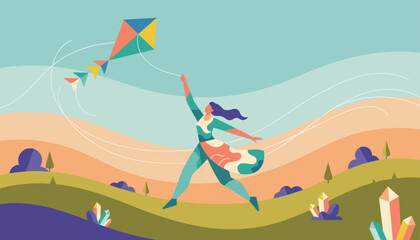 Fototapeta premium Young woman enjoying windy weather while flying colorful kite over rolling green hills and landscape on sunny day.