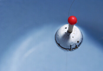 fishing bobber floating on water © saturno