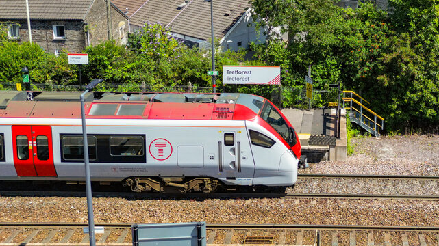 Treforest, Rhondda Cynon Taf, Wales, UK - 14 July 2026: Aerial view of a Class 756 electric train stopped at Treforest railway station in south Wales.