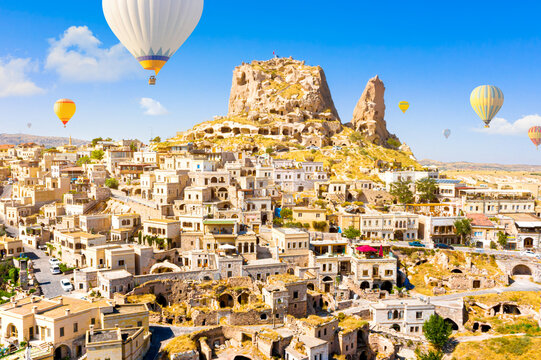 Hot air balloons flying over Uchisar Castle. Cappadocia. Nevsehir Province. Turkey