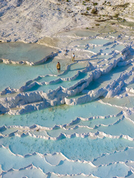 Explore the stunning travertine terraces of Pamukkale in Turkey, a natural wonder