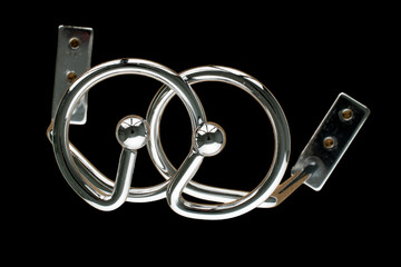 Metal chrome curtain rod Spiral on a black background, close-up. © Oleksandr