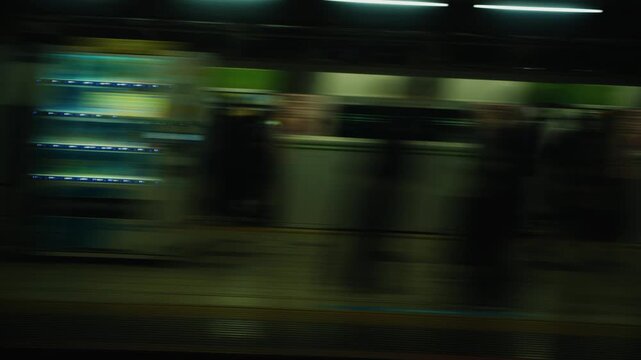 Subway train leaving station platform at night