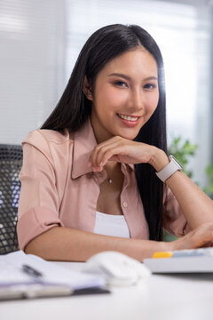 Asian woman office smile portrait desk professional shirt watch workplace business with confident expression in modern indoor workspace Vertical
