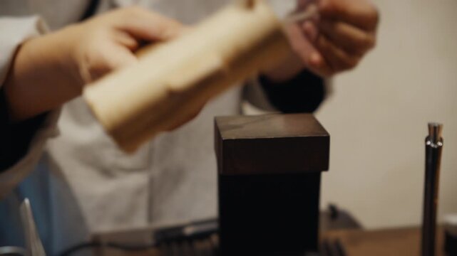 Jeweler crafting silver ring using mallet and anvil