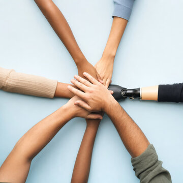 Hands join together in support and unity during a group activity in a friendly setting