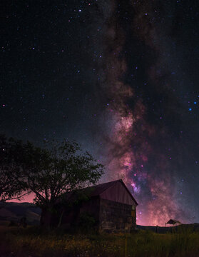Night landscape, old  Armenian small chapel on the bright Milky Way background.