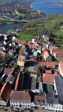 Aerial summer view of Haderslev city with historic rooftops and the lake beautifully visible in the background