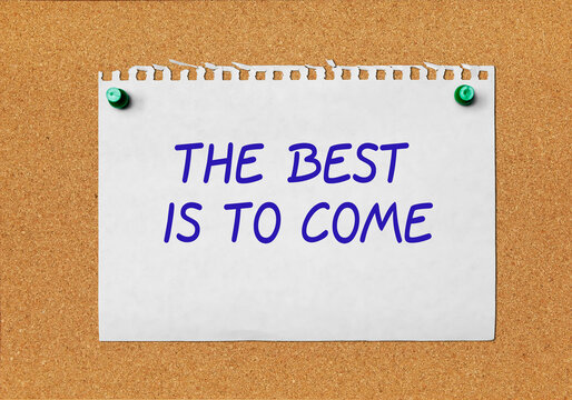 A piece of paper with a motivational inscription attached to a cork board
