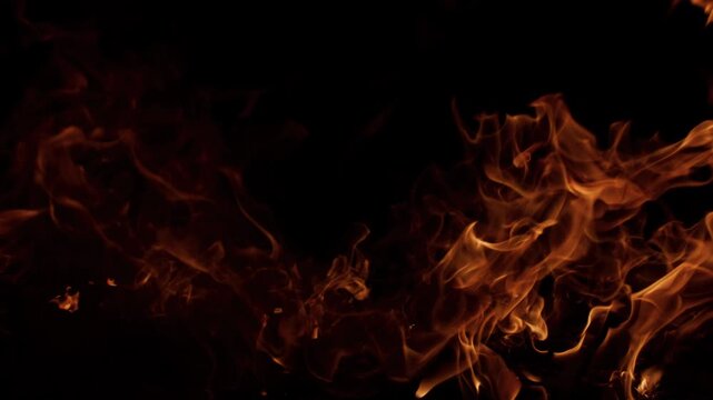 Fire flames dancing slowly. Fire burning natural combustion. Fire glowing warm light. Fire wallpaper style background.