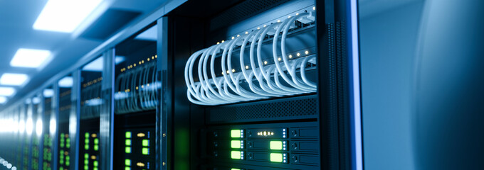 Modern Data Center Server Racks with White Network Cables and Blinking LED Lights in Blue Lit Room