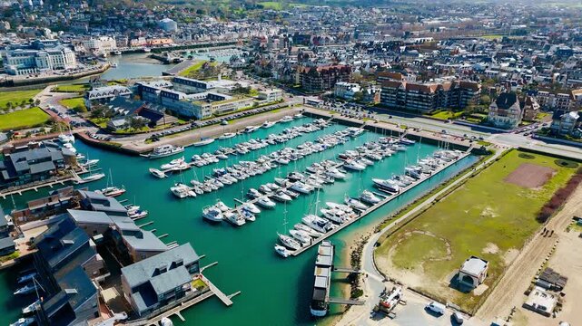 Deauville marina and resort district seen from above on Normandy coast. Yacht harbor, seaside real estate and French coastal tourism
