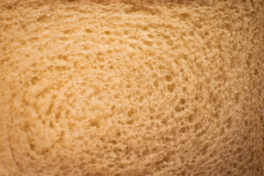 White bread in brown cut table. Slices of food warm light