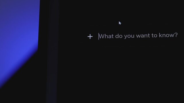 Mouse cursor clicking on an AI chatbot prompt bar. Text box on a dark laptop screen. Concept of artificial intelligence and future tech.