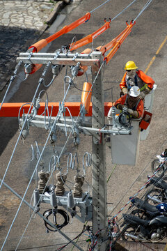 Utility Line Workers Performing Maintenance on a Power Distribution Pole in Jo&atilde;o Pessoa, Para&iacute;ba, Brazil on July 16, 2026