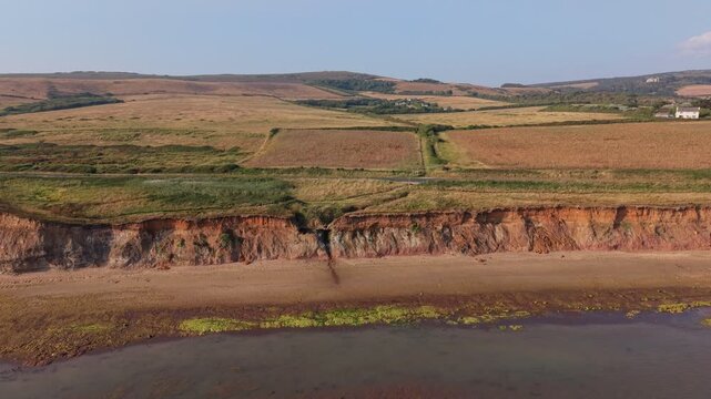 Aerial drone footage of Compton Bay and Brook Chine Beach on the south-west coast of the Isle of Wight, England, showcasing dramatic cliffs, golden sands, turquoise water, and the spectacular coast
