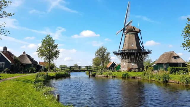 Traditional dutch windmill along a peaceful canal in the netherlands with windmill netherlands landscape waterway