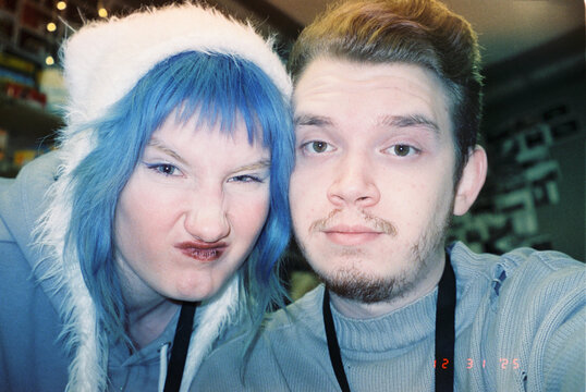 Two friends ham it up for the camera at a New Year's party