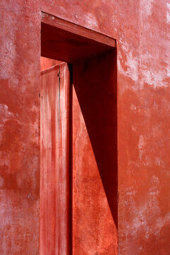 Red Wall Doorway Shadow Play