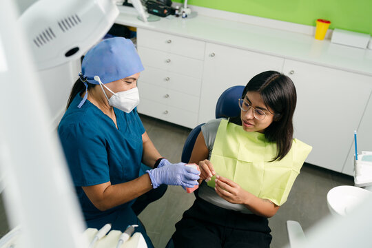 Dentist Explaining Dental Model to Patient