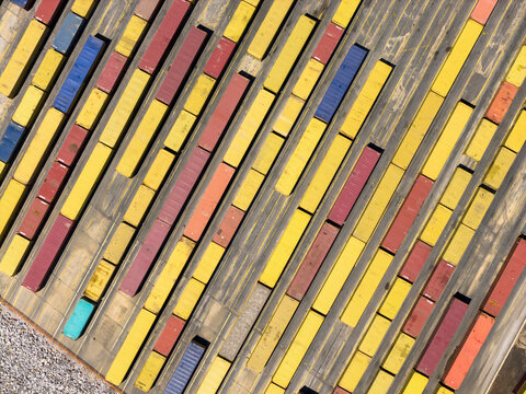 Shipping containers arranged in rows at a busy port