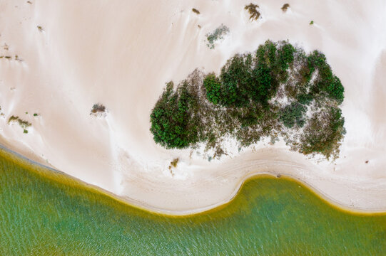 Sand dunes enveloping scrub around the shoreline of a coastal lagoon