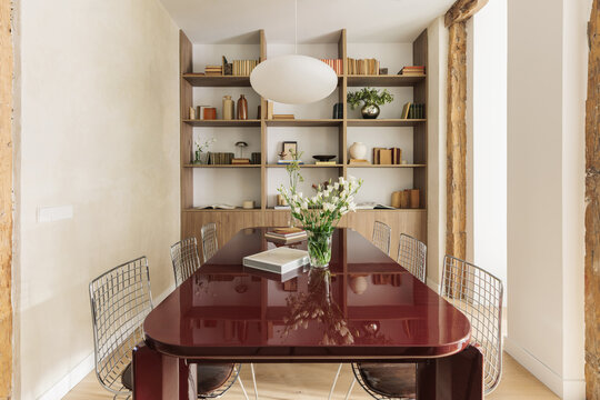 Dining room frontal view toward full-height walnut bookcase