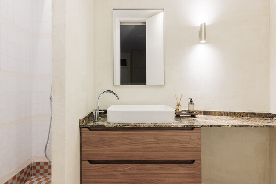 Bathroom with walnut vanity, marble top and vessel sink
