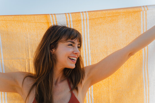 Happy woman enjoys summer vibes outdoors