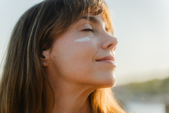 Beautiful woman soaking up the afternoon sun on the beach