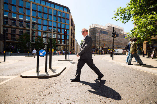 Businessman crosses the street