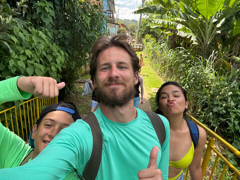 UGC Selfie Of Group Enjoys Outdoor Fun on a Tropical Path 