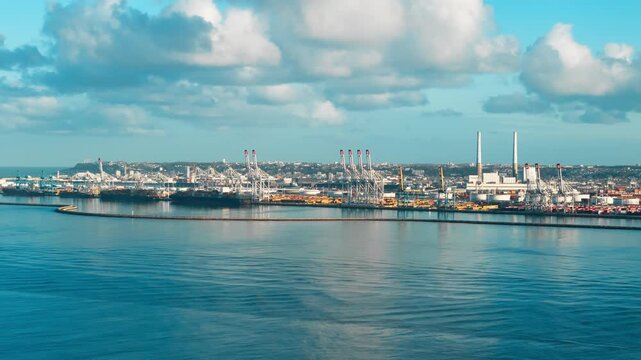 Large container terminal works with cargo ships and port cranes near coastline. Global sea transport infrastructure for trade and freight logistics