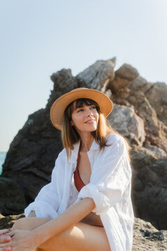 Happy woman enjoys the afternoon summer sun at the beach