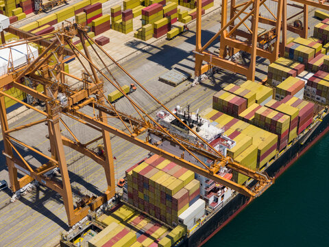 Cargo ship loading containers at port.