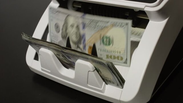 Counting hundred dollar bills. Money counting process. Business and finance. Cash counting machine in motion. Investment and banking concept with Counting money.