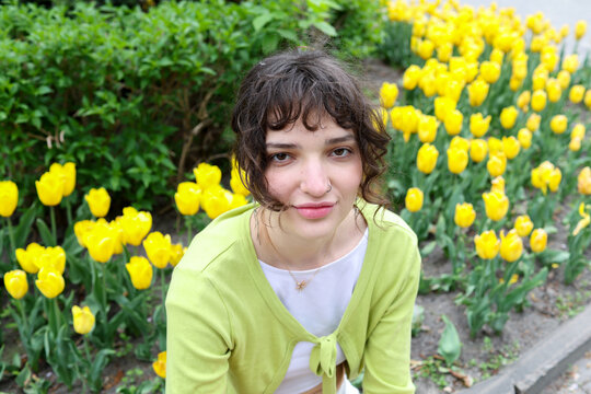 A young woman is walking in the park.