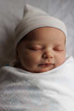 Sleeping Newborn in Hospital Hat