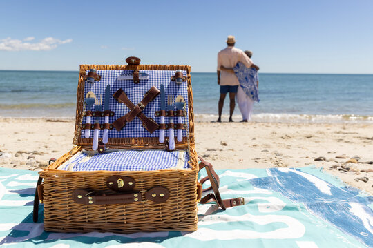 Senior Black Couple walk beach picnic basket 