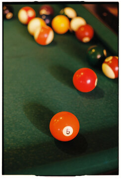 Close Up of Billiard Balls Number Five on Green Pool Table