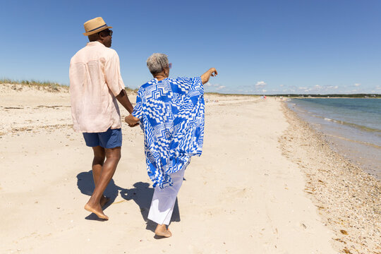 Senior Black Couple point walk beach 