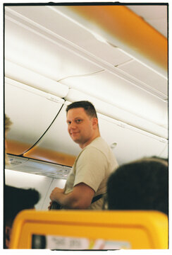 Man Smiling Inside Airplane Cabin on Flight to Madeira Portugal