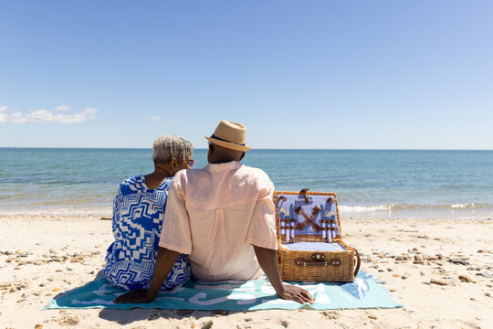 Senior Black Couple rest  beach picnic basket 