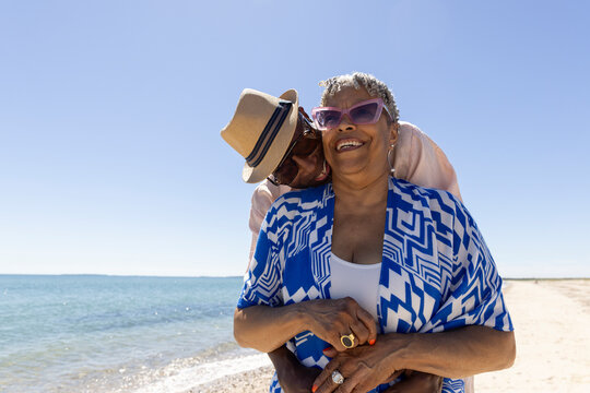 Senior Black Couple in love walk beach 